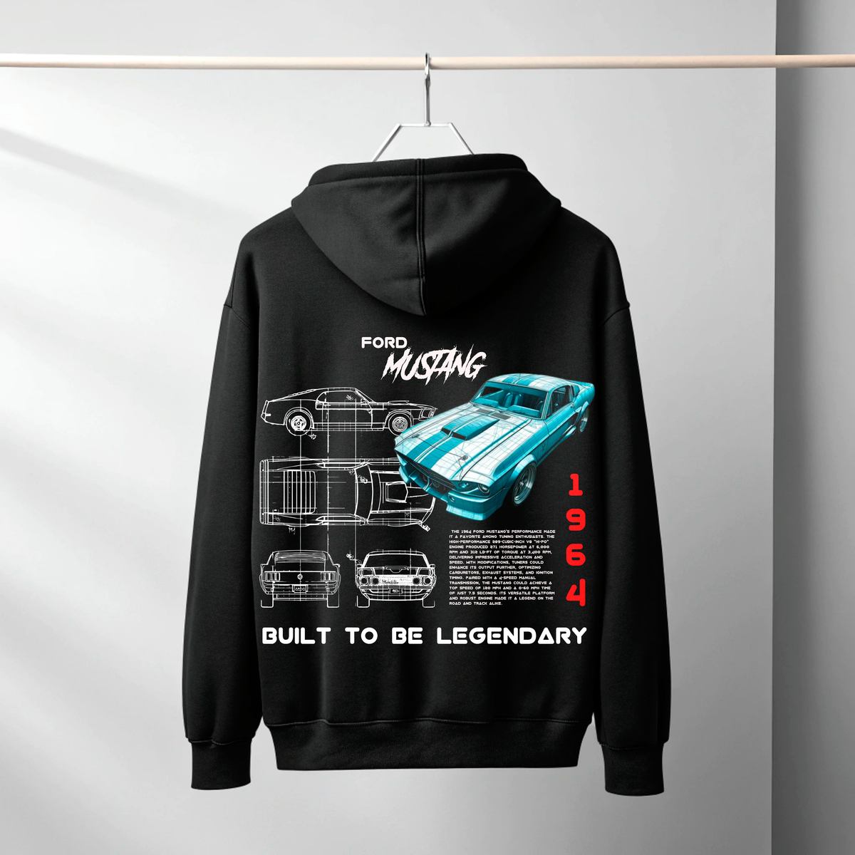 A black hoodie hanging on a hanger against a light gray wall, featuring a large back graphic of a 1964 Ford Mustang with blueprint-style drawings, a turquoise car illustration, and the text 'FORD MUSTANG', 'BUILT TO BE LEGENDARY', and '1964'.
